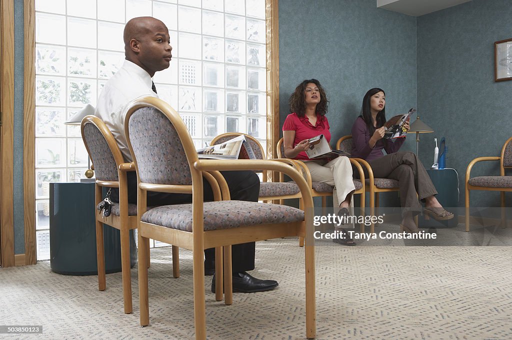 People sitting in dental office waiting room