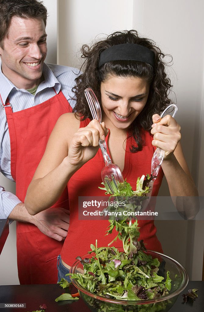 Couple cooking together in kitchen