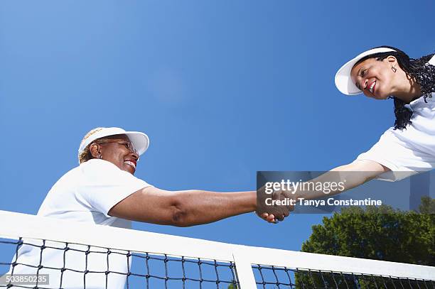 tennis players shaking hands at net - fair stock-fotos und bilder