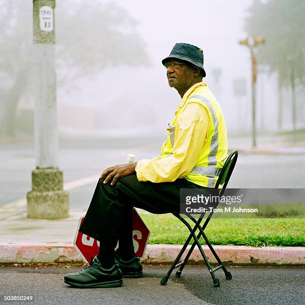 crossing guard sitting at crosswalk - 交通誘導員 ストックフォトと画像