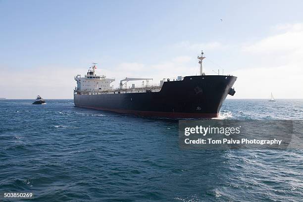 oil tanker with tugboat at sea - industrial sailing craft 個照片及圖片檔