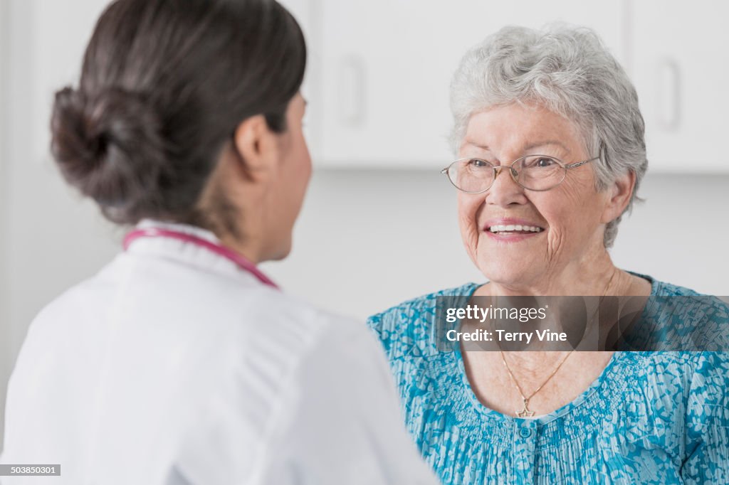 Doctor talking to patient in office