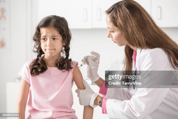 doctor giving patient a shot in office - needle injury stock pictures, royalty-free photos & images