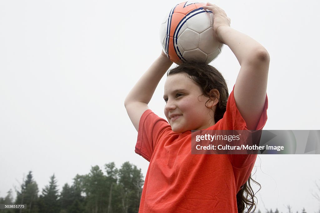 Girl holding soccer ball