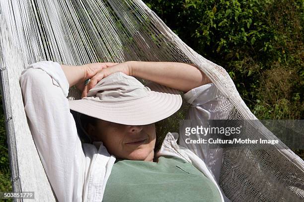 woman relaxing in hammock - shade45 stock pictures, royalty-free photos & images