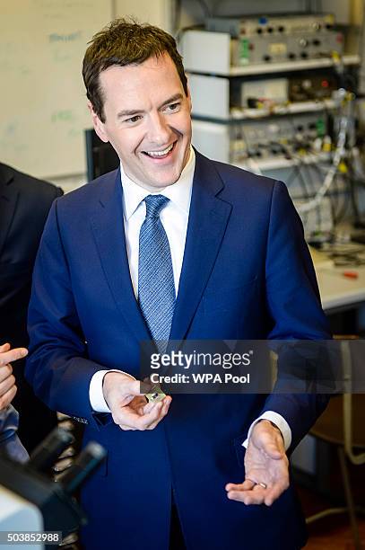 Chancellor of the Exchequer George Osborne holds a microchip during his visit to the Cardiff School of Physics and Astronomy prior to delivering a...