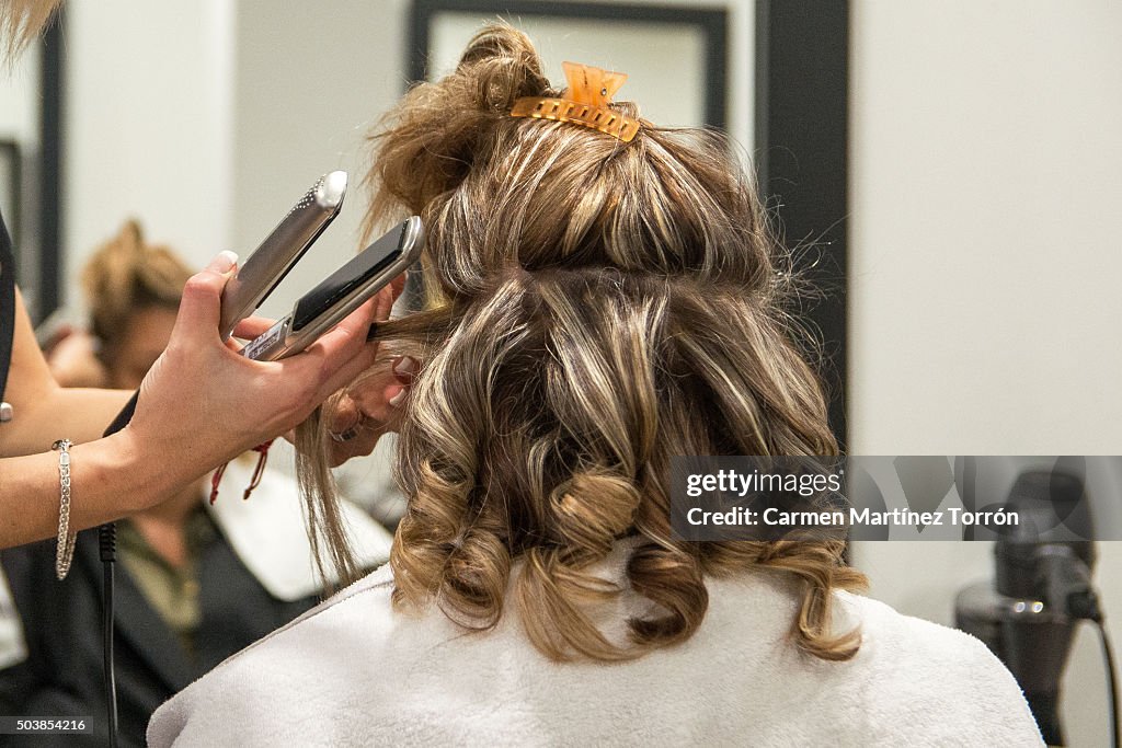 Hairdresser working with curling iron