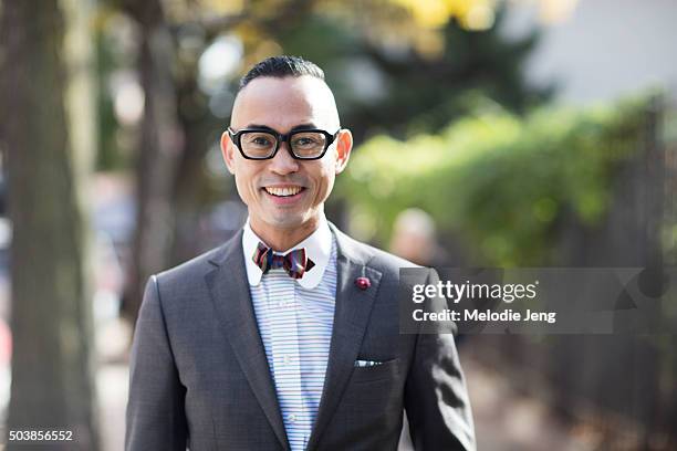 Enrique Crame of Fine And Dandy shop wears TVR OPT 501 black frames glasses, a Coffee Suit Blazer by Massimo Dutti, bow tie, pocket square,...