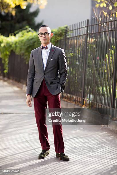 Enrique Crame of Fine And Dandy shop wears TVR OPT 501 black frames glasses, a Coffee Suit Blazer by Massimo Dutti, bow tie, pocket square, and...