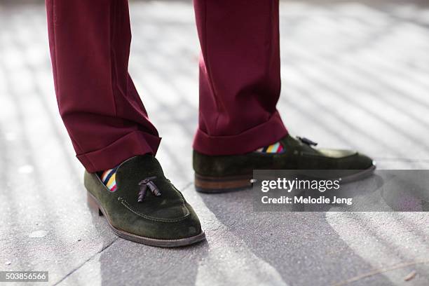 Enrique Crame of Fine And Dandy shop wears Burgundy pleated trousers by MySuit, colorful striped socks, and Olive suede loafers by Massimo Dutti in...