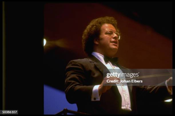 Conductor James Levine leading the Metropolitan Opera orchestra during an opera performance.