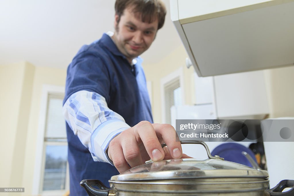 Man with Aspergers living in his home and cooking