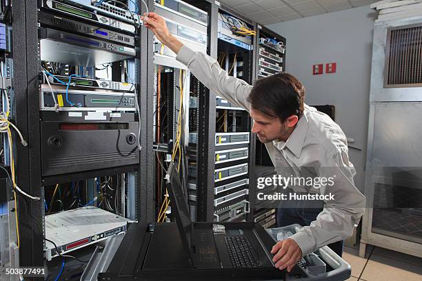 network engineer configuring a data switch - configuring stock pictures, royalty-free photos & images