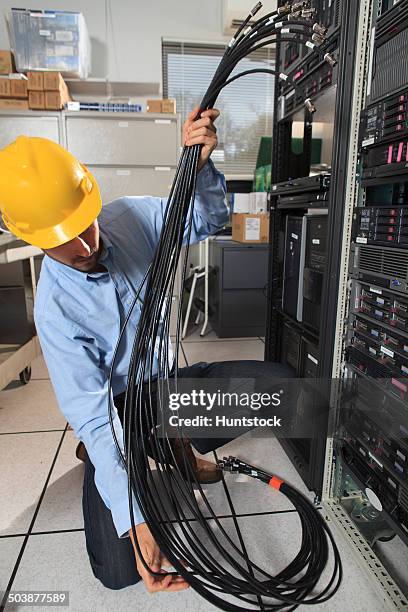 network engineer preparing structured cabling for data center - structured cabling stock pictures, royalty-free photos & images