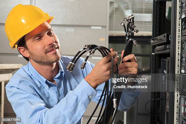network engineer preparing structured cabling for data center - tomada de ligação à rede imagens e fotografias de stock