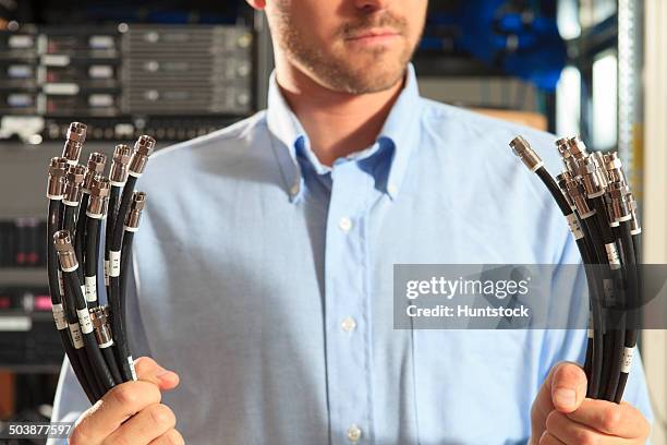 network engineer preparing structured cabling for data center - coaxial cable stock pictures, royalty-free photos & images