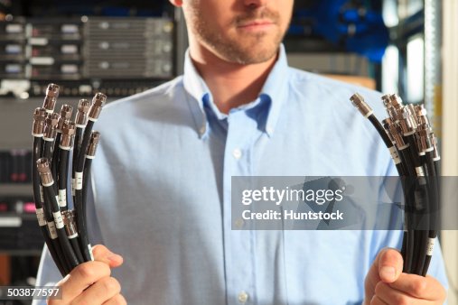 Network engineer preparing structured cabling for data center Network engineer preparing structured cabling for data center