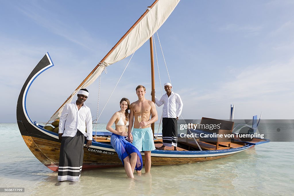 Portrait of couple with crew on dhoni boat