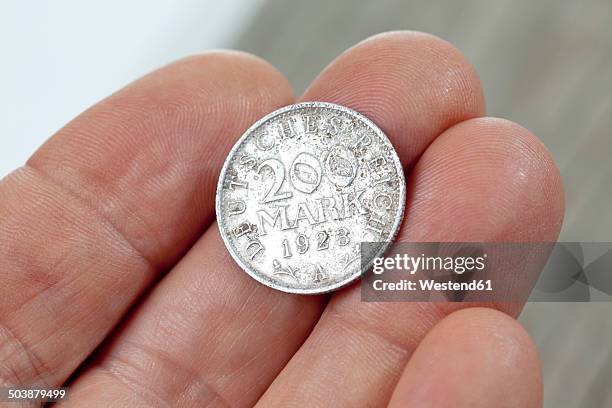 german reichsmark coin from the 1920s in hand - german coin stock pictures, royalty-free photos & images