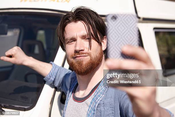 man taking selfie in front of car - know it all stock pictures, royalty-free photos & images