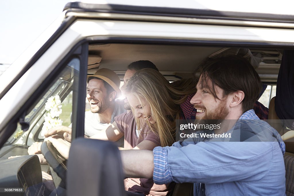 Happy friends in minivan