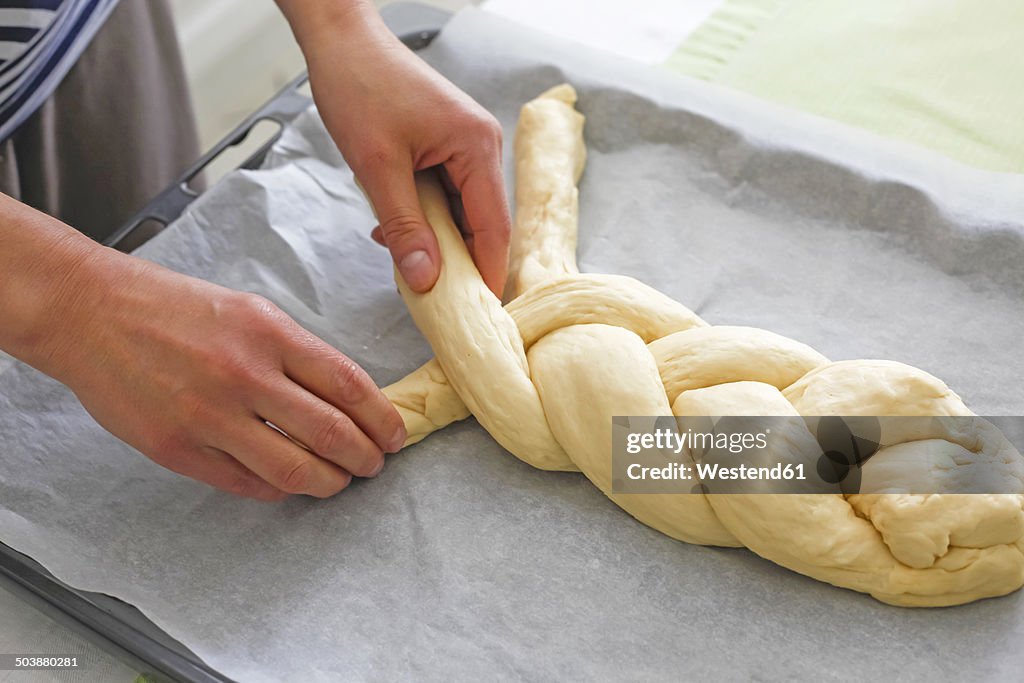 Germany, braiding a braided yeast bun