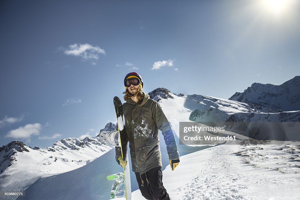 Austria, Vorarlberg, Riezlern, Snowboarder in the mountains