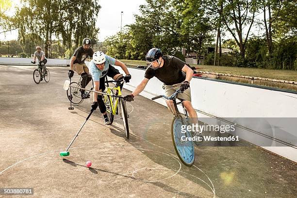 germany, hannover, group of men playing bike polo - polo stock pictures, royalty-free photos & images