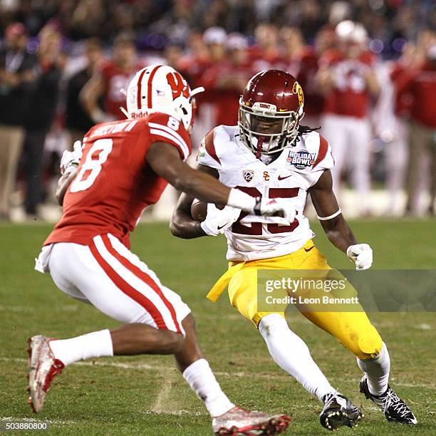 Sojourn Shelton of the Wisconsin Badgers tackles Ronald Jones II of USC Trojans in a Wisconsin 23-21 win during the National University Holiday Bowl...