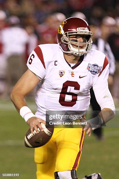 Cody Kessler of the USC Trojans looks to pass the ball against the Wisconsin Badgers during the National University Holiday Bowl at Qualcomm Stadium...