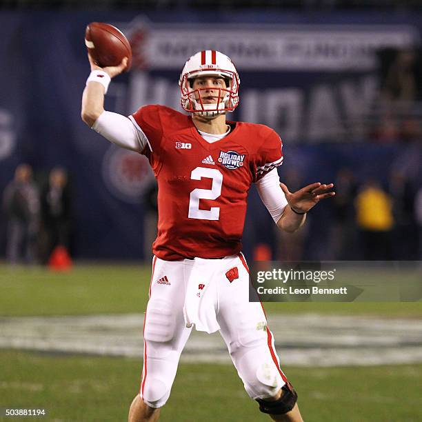 Joel Stave of the Wisconsin Badgers looks to pass the ball against the USC Trojans during a 23-21 Wisconsin win during the National University...