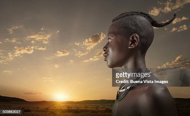 young himba man at sunset - himba imagens e fotografias de stock