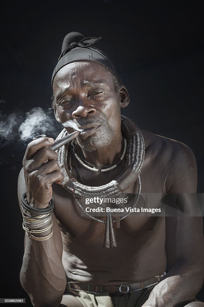 Himba man smocking  pipe