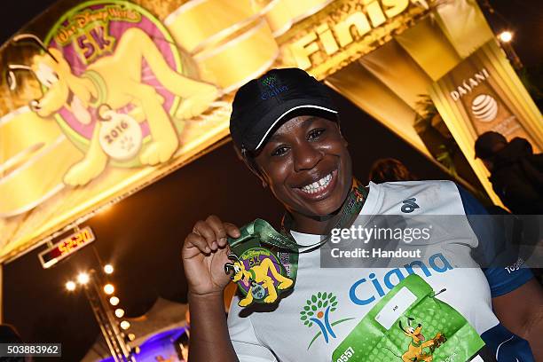 In this handout photo provided by Disney Parks, Emmy Award-winning actress Uzo Aduba proudly showcases her participation medal after completing the...