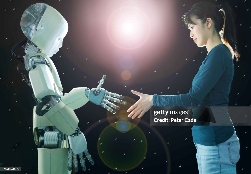 Woamn shaking hands with robot