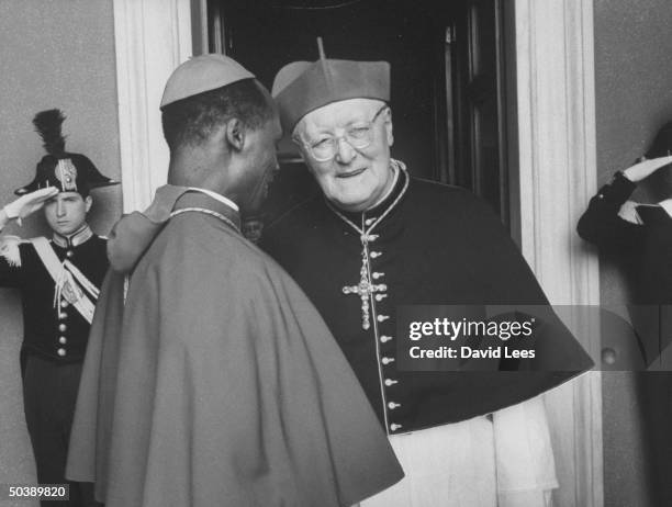 Cardinal Laurian Rugambwa talking with Cardinal Michael Browne during the Conclave of Cardinals to elect new Pope.