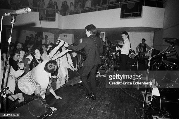 Punk fans crowd the front of the stage to watch The Jam perform at the Royal College of Art, London, 29th April 1977.