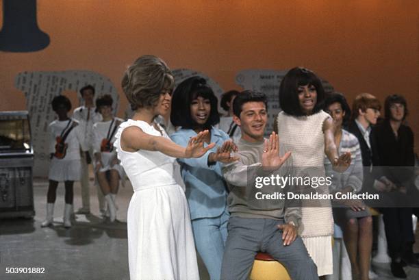 Host Frankie Avalon joins singers, Mary Wilson, Florence Ballard and Diana Ross of the R and B Group 'The Supremes' as they rehearse for their...