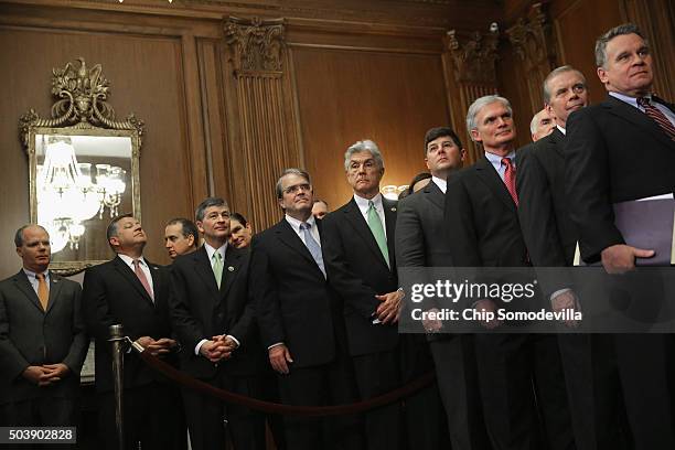 Republican members of the House of Representatives line up to watch Speaker of the House Paul Ryan sign legislation to repeal the Affordable Care...