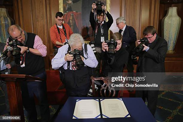 Journalists photograph legislation to repeal the Affordable Care Act, also known as Obamacare, and to cut off federal funding of Planned Parenthood...