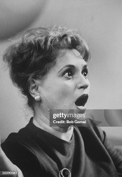 Actress Judy Holliday watching a private showing of an old Harold Lloyd movie.