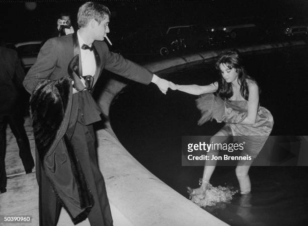 American actress Jeri Elam , emerging from a fountain during the film festival.