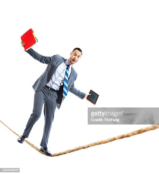 businessman balancing work life on a tightrope - tightrope stock pictures, royalty-free photos & images