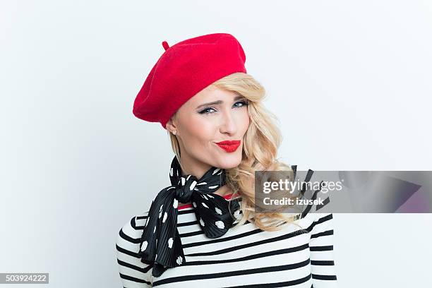 sensual blonde french woman wearing red beret - beret stock pictures, royalty-free photos & images