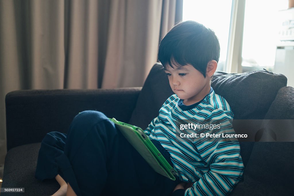 Boy looking at a tablet PC