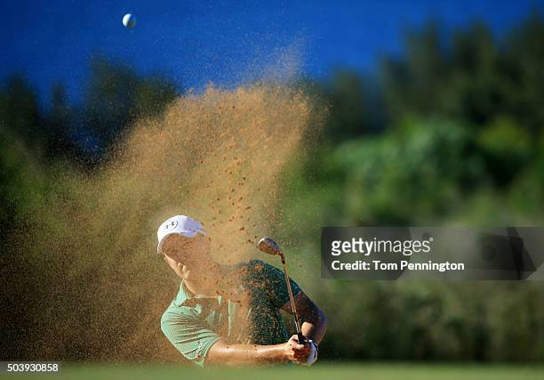 Jordan Spieth plays a shot from a bunker on the 14th hole during round one of the Hyundai Tournament of Champions at the Plantation Course at Kapalua...