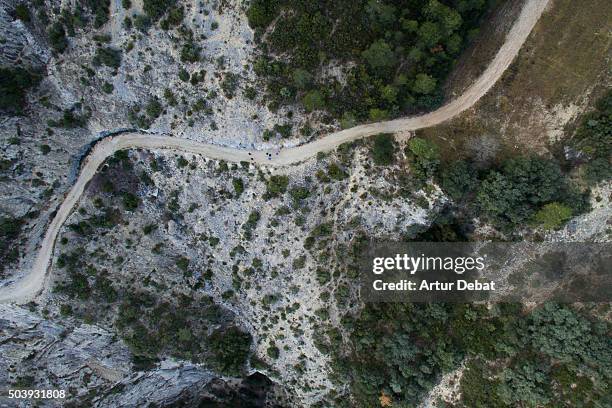 aerial view of rocky mountain path with people in the pyrenees mountains. - pirineos fotografías e imágenes de stock