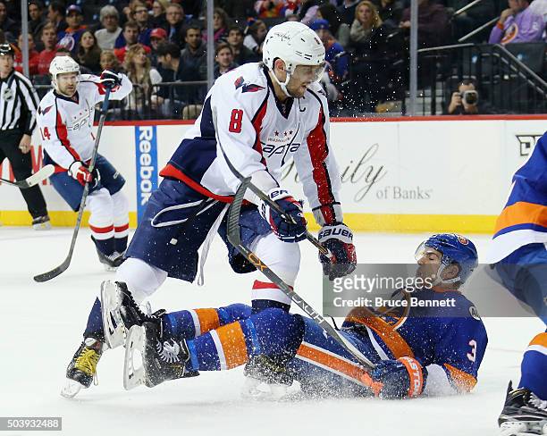 Alex Ovechkin of the Washington Capitals checks Travis Hamonic of the New York Islanders during the third period at the Barclays Center on January 7,...