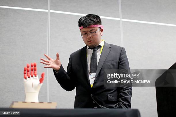 BrainCo CEO Bicheng Han wears the BrainCo Focus 1 to use bio feedback to try concentrate on manipulate a mechanical hand using his brain during a...