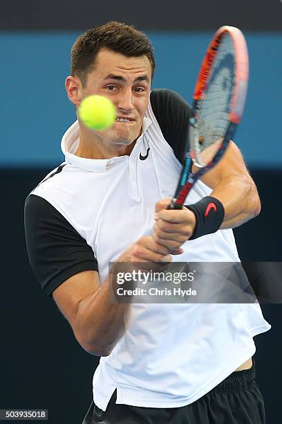 Bernard Tomic of Australia plays a backhand in his quarter final matach against Kei Nishikori of Japan during day six of the 2016 Brisbane...